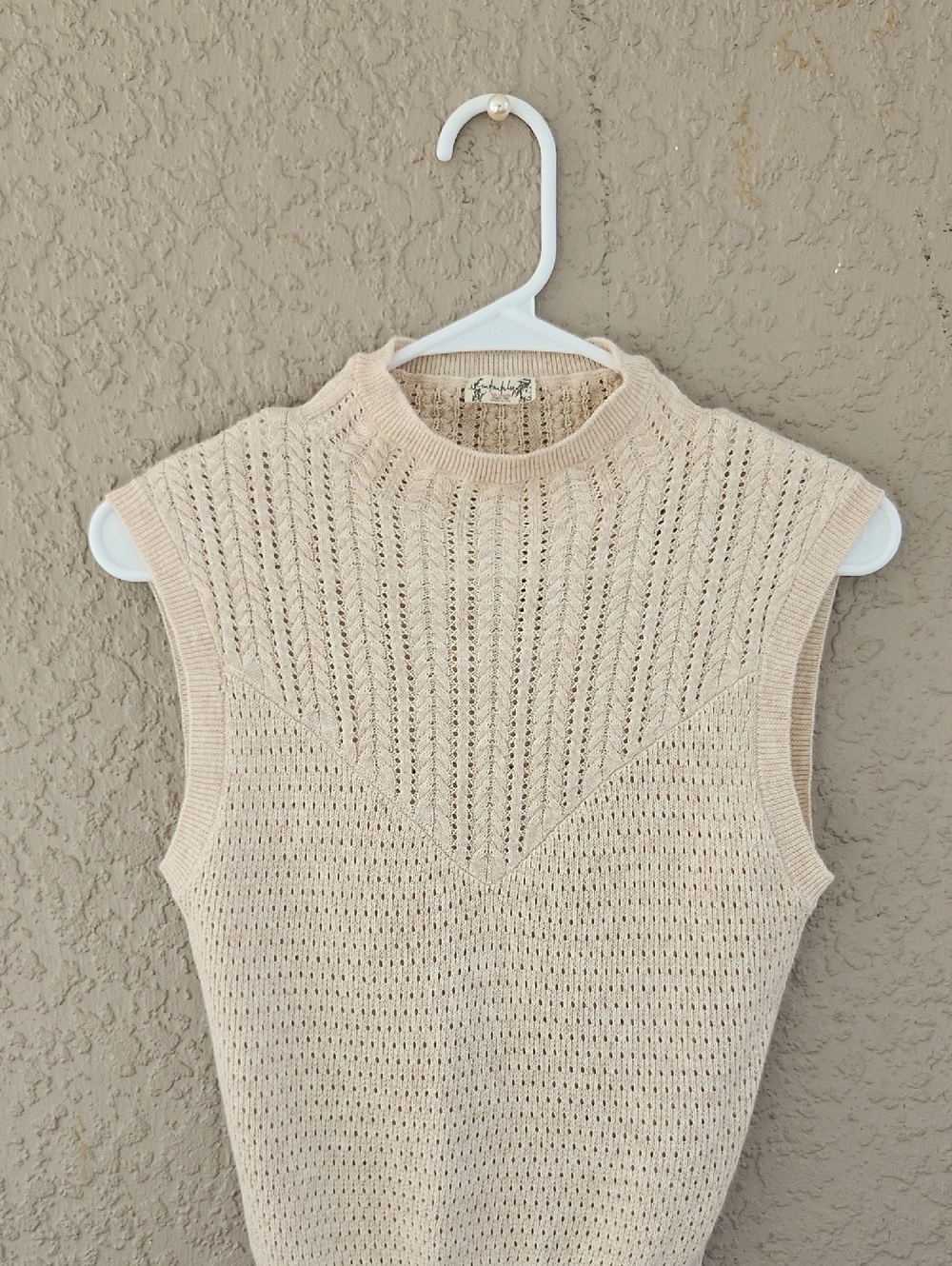 Free People Modern Cable Knit Mock Neck Vest in the color Heather Oatmeal.